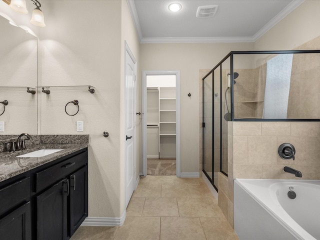 bathroom with a garden tub, visible vents, a spacious closet, a shower stall, and crown molding