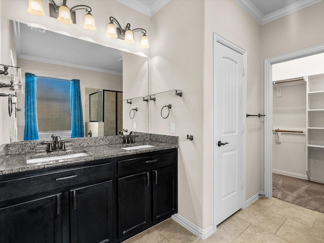 bathroom with ornamental molding, a stall shower, a sink, and a spacious closet