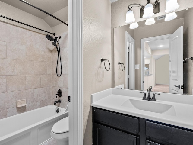 bathroom featuring toilet, a textured wall, vanity, and shower / bathtub combination