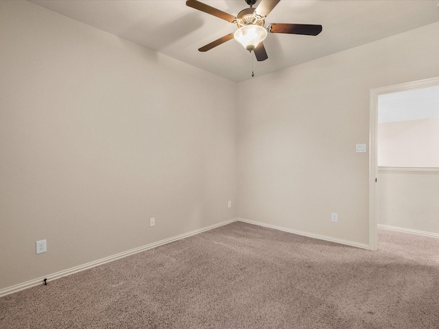 spare room featuring carpet floors, baseboards, and a ceiling fan