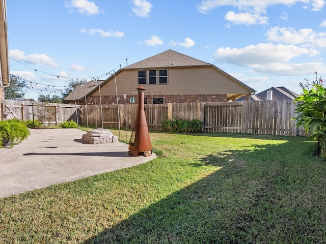 view of yard with a patio area and a fenced backyard