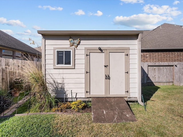 view of shed featuring fence