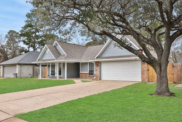 view of front of property featuring concrete driveway, an attached garage, fence, a front lawn, and brick siding