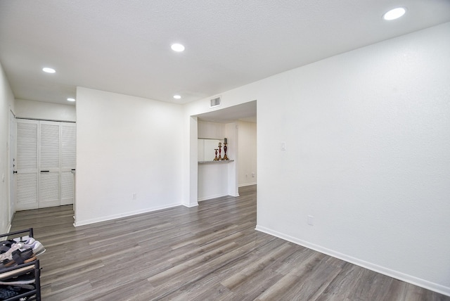 interior space featuring recessed lighting, visible vents, baseboards, and wood finished floors