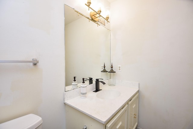 half bath with vanity, toilet, and an inviting chandelier