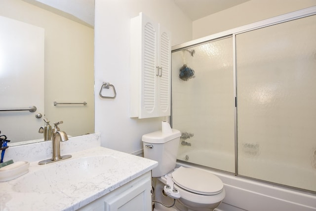 full bath with toilet, bath / shower combo with glass door, and vanity