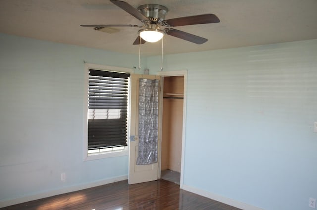 unfurnished bedroom with ceiling fan, a closet, baseboards, and wood finished floors