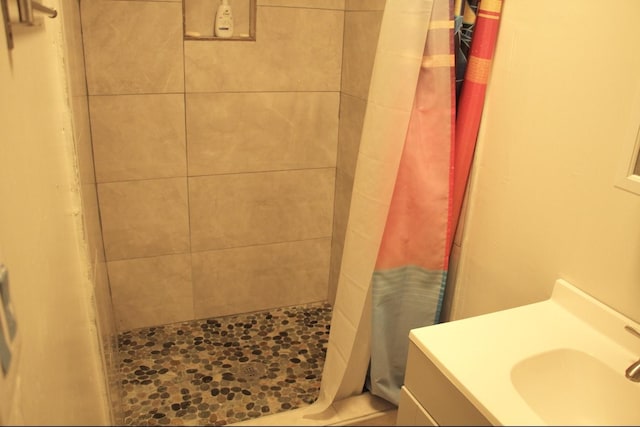 bathroom with a stall shower and vanity