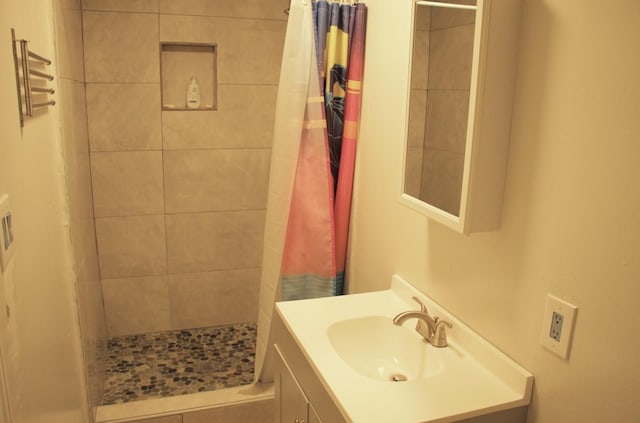 full bathroom with a shower stall and vanity