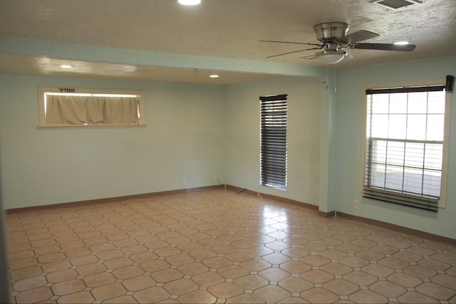 spare room with recessed lighting, visible vents, a ceiling fan, a textured ceiling, and baseboards