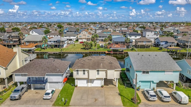 birds eye view of property featuring a water view and a residential view