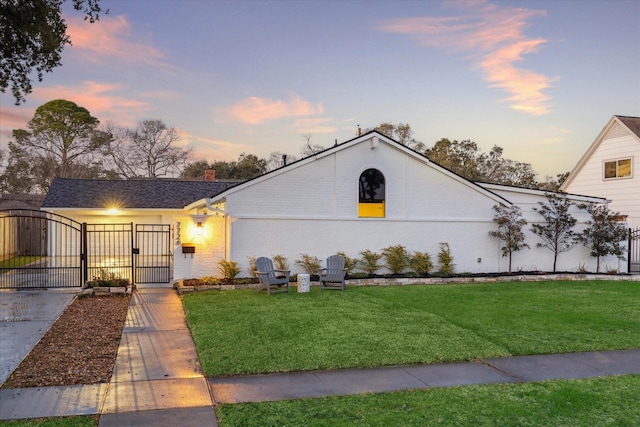 view of front of home featuring a front yard, a gate, fence, and a chimney