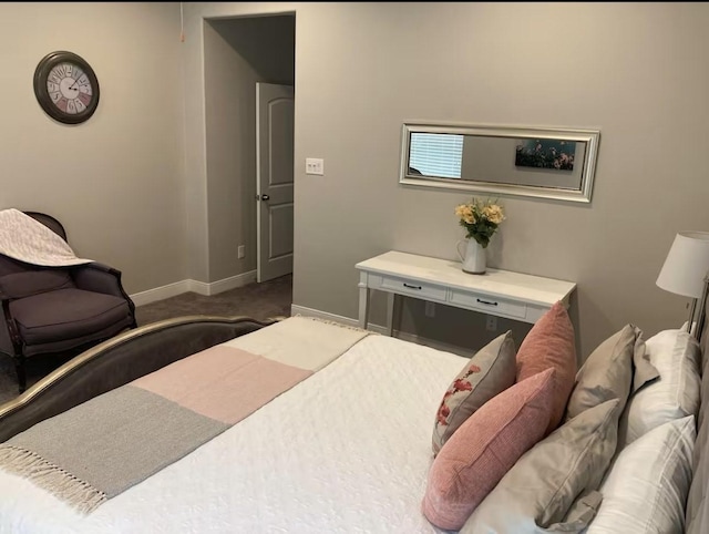 bedroom featuring carpet and baseboards