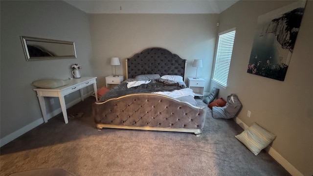 bedroom with baseboards, vaulted ceiling, and carpet flooring