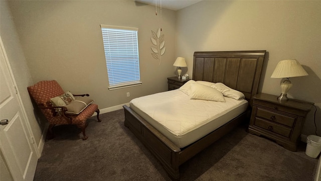 bedroom featuring dark colored carpet and baseboards