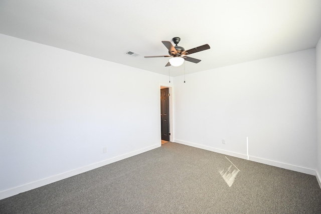 spare room with a ceiling fan, carpet flooring, visible vents, and baseboards