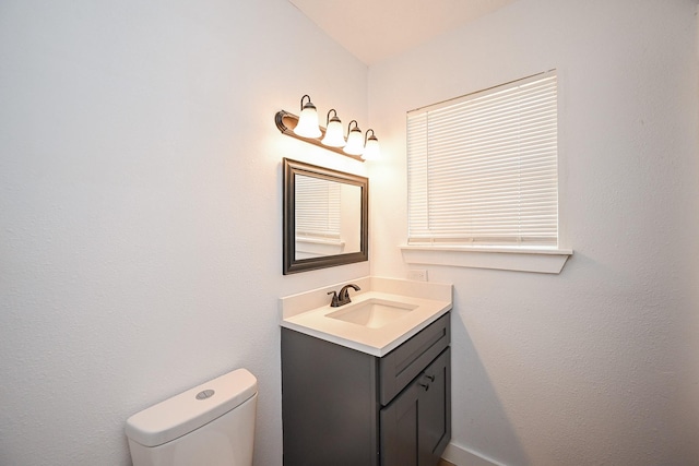 bathroom featuring toilet and vanity