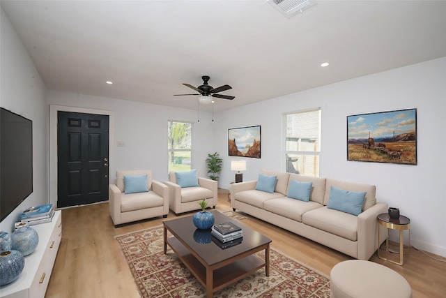 living room with a ceiling fan, recessed lighting, visible vents, and light wood-style floors