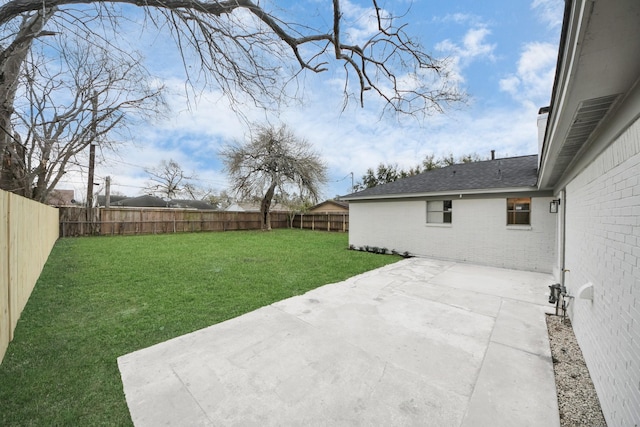 view of yard with a patio area and a fenced backyard