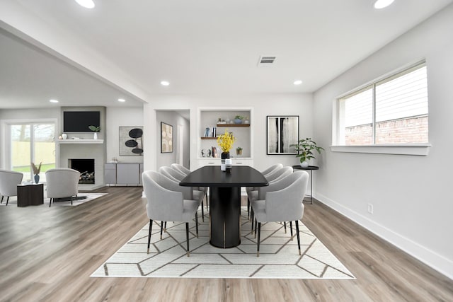 dining area featuring wood finished floors, visible vents, and recessed lighting