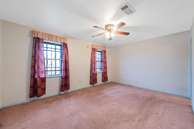 unfurnished room featuring a ceiling fan, carpet, visible vents, and baseboards