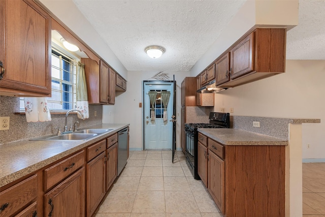 kitchen with brown cabinets, black gas range oven, a sink, dishwasher, and under cabinet range hood