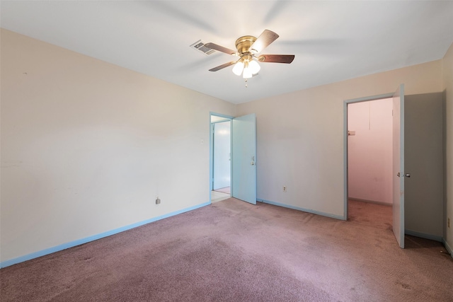 unfurnished room with a ceiling fan, baseboards, and carpet flooring