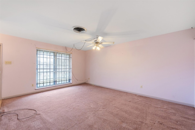 unfurnished room featuring baseboards, visible vents, and light colored carpet