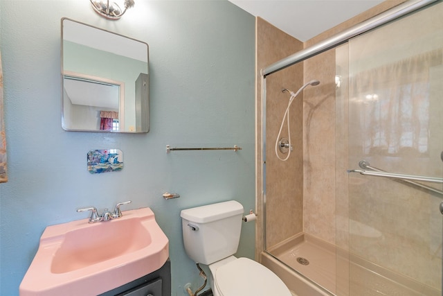 full bath with a stall shower, vanity, and toilet