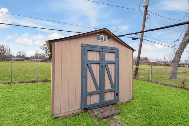 view of shed featuring fence