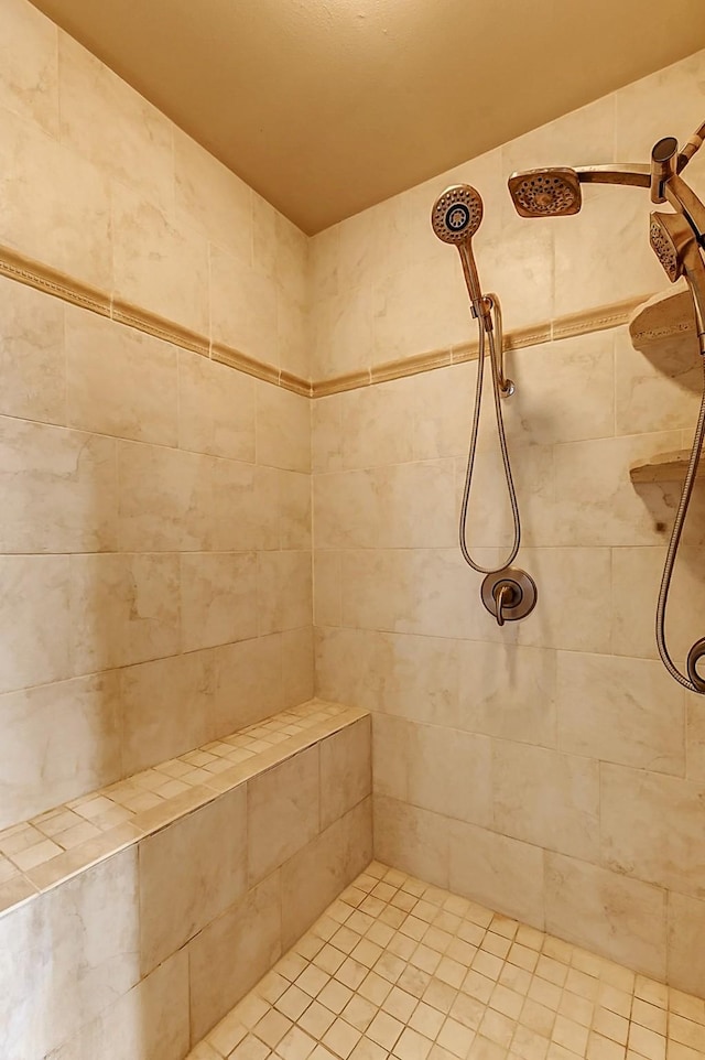 bathroom with tiled shower