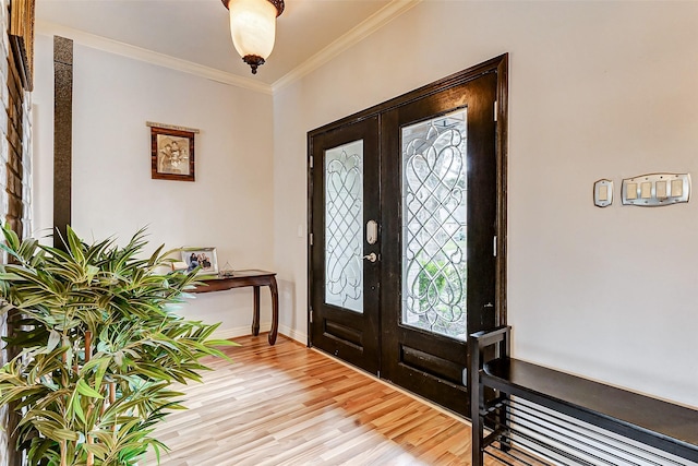 entryway with light wood-type flooring, french doors, baseboards, and ornamental molding