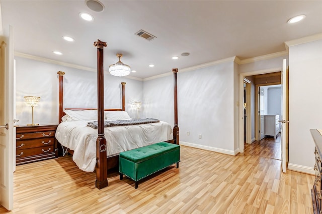 bedroom featuring visible vents, light wood-style floors, and ornamental molding