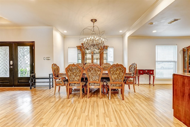 dining space featuring visible vents, light wood-style flooring, recessed lighting, french doors, and a chandelier