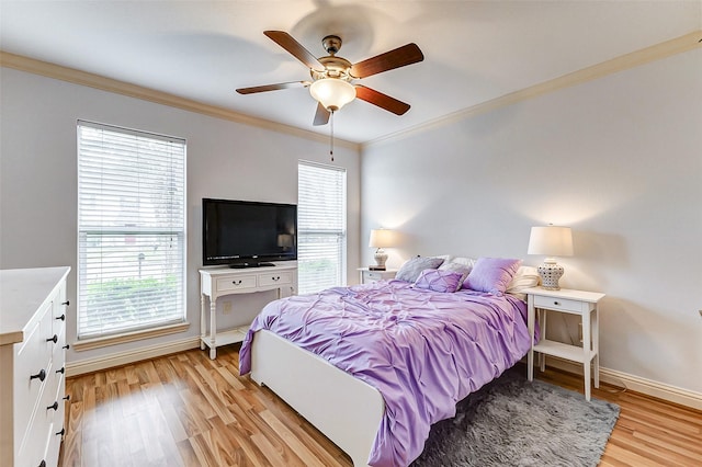 bedroom with a ceiling fan, light wood-type flooring, baseboards, and ornamental molding