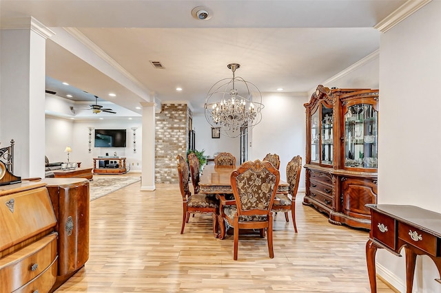 dining room featuring crown molding, decorative columns, visible vents, and light wood finished floors