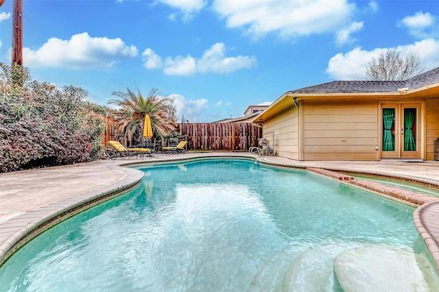 view of swimming pool featuring a patio, french doors, a fenced in pool, and a fenced backyard