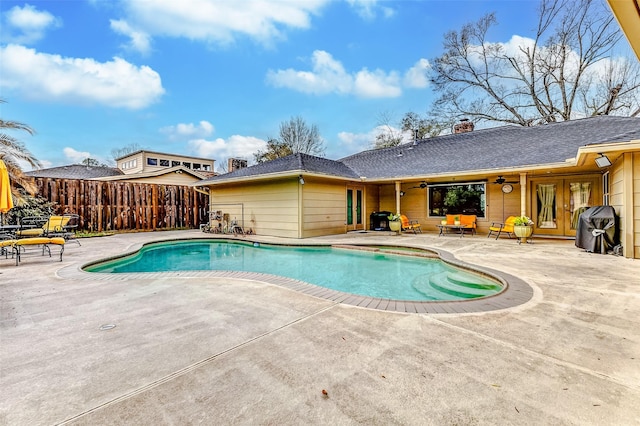 outdoor pool featuring a patio area, area for grilling, ceiling fan, and fence