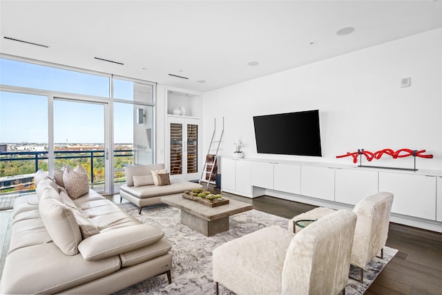 living area with dark wood-style floors and a wall of windows