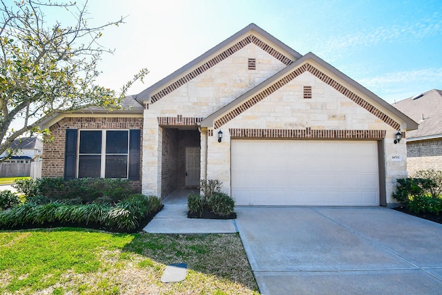 24703 Heirloom Ln, Katy, TX 77493 - french country style house with stone siding, an attached garage, driveway, and brick siding