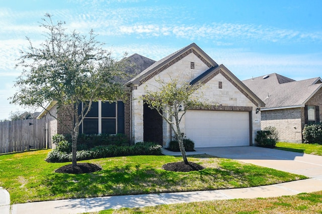 view of front of property featuring an attached garage, fence, concrete driveway, stone siding, and a front lawn