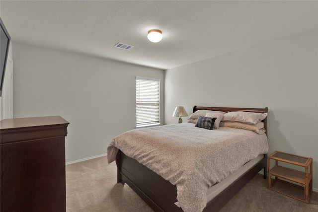 bedroom with carpet, visible vents, and baseboards