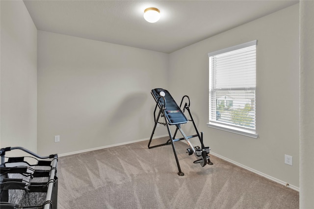 workout area with carpet flooring and baseboards