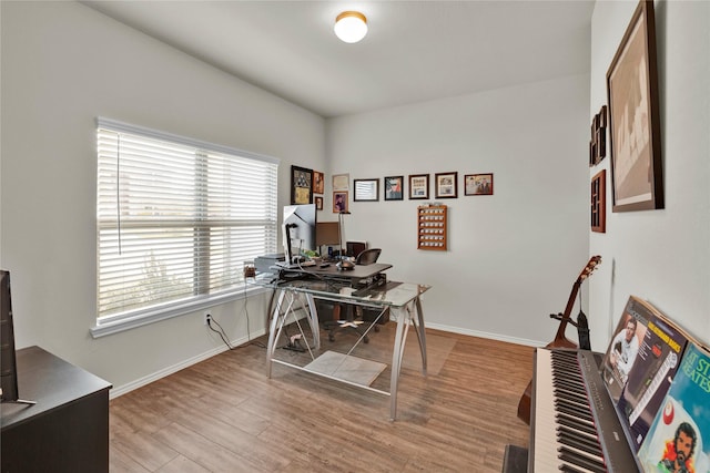 office space featuring baseboards and wood finished floors