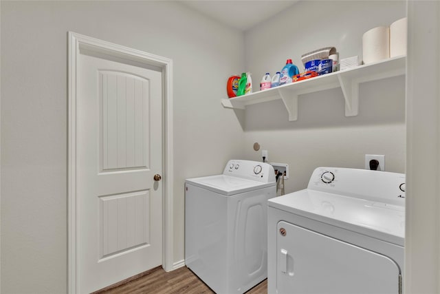 laundry area featuring laundry area, washer and clothes dryer, and light wood-type flooring