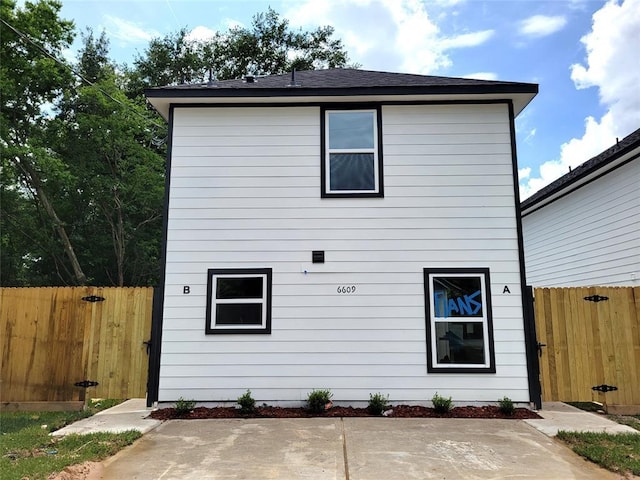 rear view of house featuring a patio area and fence