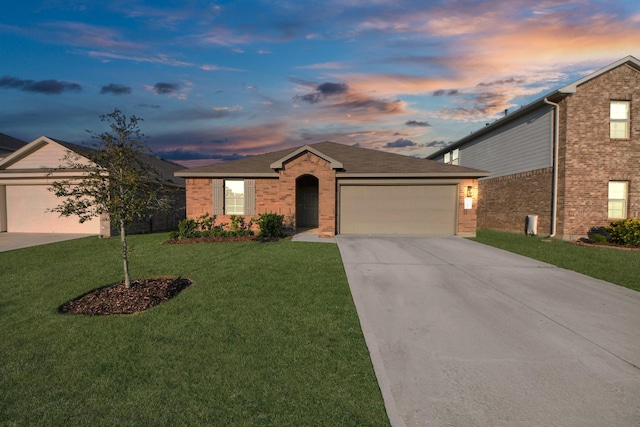 view of front of property with a garage, driveway, a front lawn, and brick siding