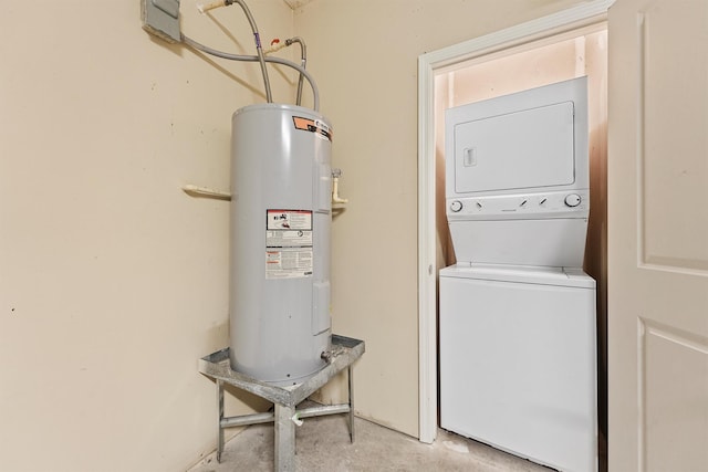 laundry room featuring water heater and stacked washer / drying machine