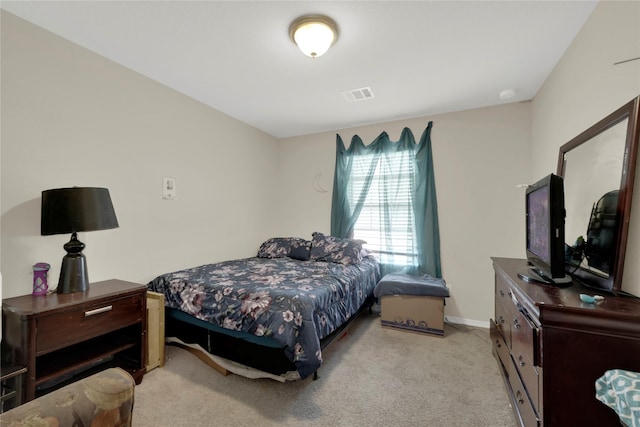 bedroom with carpet floors, baseboards, and visible vents