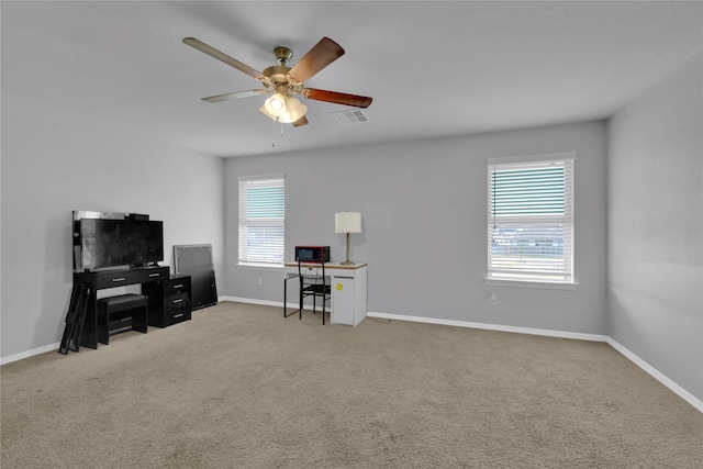 carpeted home office featuring visible vents, ceiling fan, and baseboards